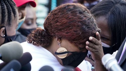 Tamika Palmer, the mother of Breonna Taylor (centre) listens to a news conference, Friday, September 25, 2020, in Louisville, Kentucky