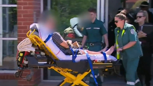 The 49-year-old man was taken to hospital, with his hands placed in paper bags. he has been charged with murder.