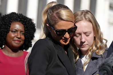 Actress and model Paris Hilton (2nd L) shares a moment with 12-year-old child abuse survivor Uvea Spezza-Lopin (R) of Junction City, Oregon during a news conference outside the U.S. Capitol October 20, 2021 in Washington, DC.