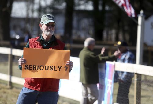 The protesters have taken aim at the church for holding the ceremony just weeks after their beloved gun was used to kill 17 people in Florida. (AAP)