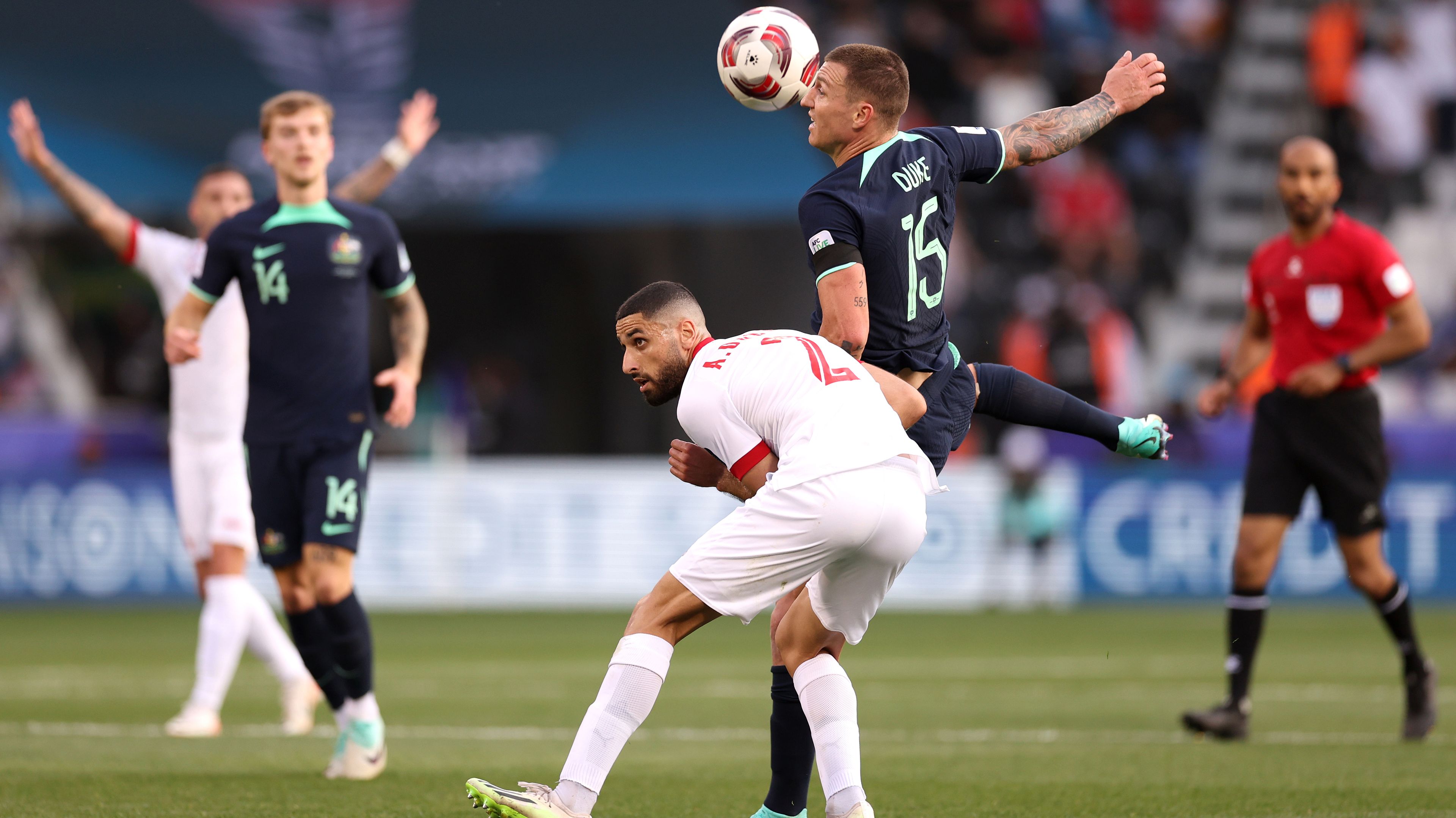 Mitchell Duke of Australia battles for possession with Aiham Ousou of Syria.