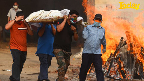 Family members carry the body of a COVID-19 victim at Gazipur crematorium on April 28, 2021 in New Delhi, India. (Photo by Raj K Raj/Hindustan Times via Getty Images)