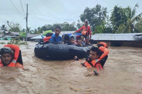 Rescuers use boats to evacuate residents from flooded areas due to Tropical Storm Nalgae at Parang, Maguindanao province, southern Philippines on Friday Oct. 28, 2022. (Philippine Coast Guard via AP)
