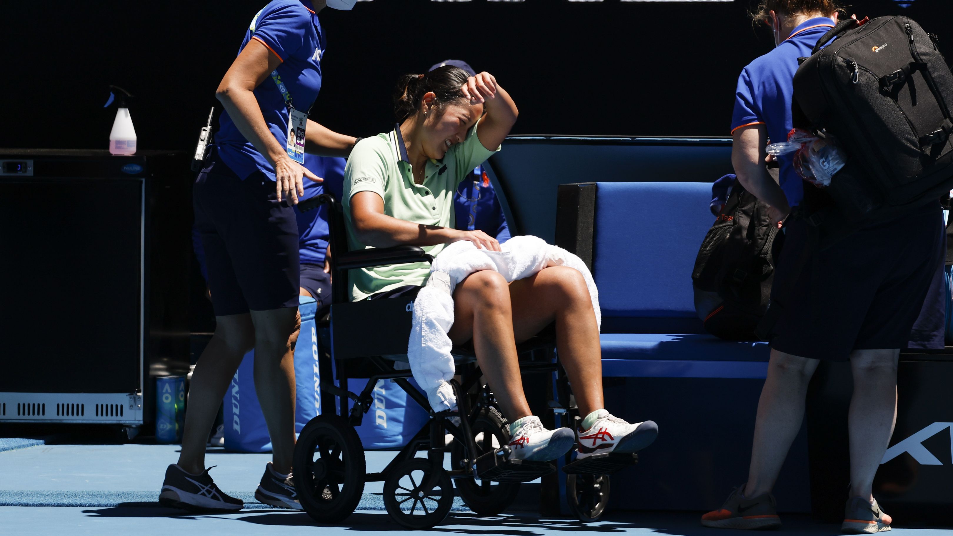 Harmony Tan of France is taken from the court in a wheelchair during her second round match against Elina Svitolina.