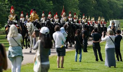 Members of the Household Cavalry make their way down the Long Walk towards Windsor Castle ahead of the ceremony.