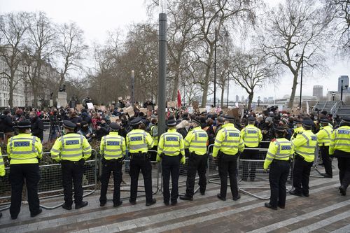 Police take measures as mourners for the life of murdered 33-year-old Sarah Everard, whose remains were found this week, take part in a demonstration outside New Scotland Yard in London