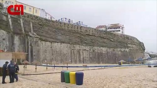 The large stone wall sits 30m above the popular surf beach. (Image: Correio Da Manha)