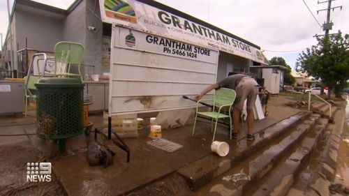 Grantham residents in Queensland return to their homes and businesses, which have been damaged by floodwaters. 