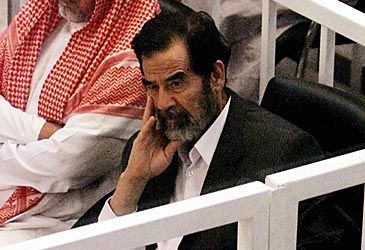 When did Saddam Hussein go on trial for crimes against humanity?