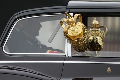 Cars carrying the crown leave Buckingham Palace for the State Opening of Parliament, at the Palace of Westminster in London, Tuesday, May 10, 2022. 