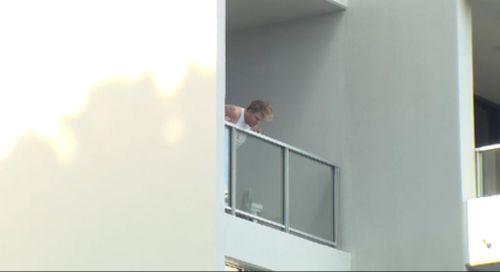 A man surveys the crime scene after a woman fell to her death from a Gold Coast balcony. (9NEWS)