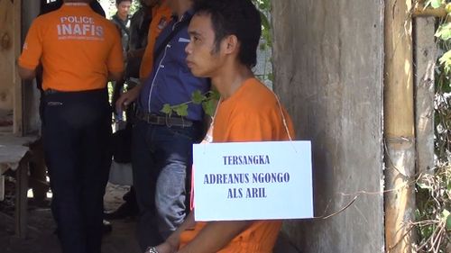 One of the alleged plotters Adrianus Ngongo alias "Aril". All of the group wore orange jumpsuits and signs stating their name during the re-enactment. (9NEWS)