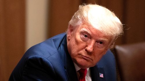 President Donald Trump listens during a roundtable discussion with African-American supporters in the Cabinet Room of the White House