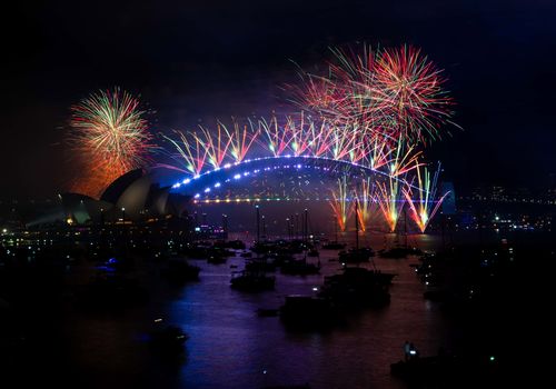 Fireworks light up the skies above Sydney Harbour at midnight on New Year's Eve. 31st December 2022
