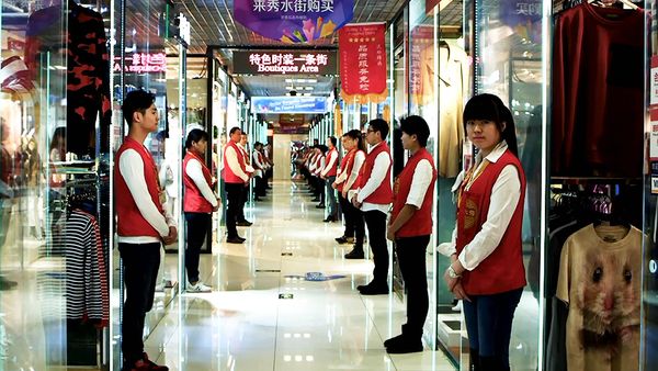 Market salespeople lined up in uniform (Silk Street)