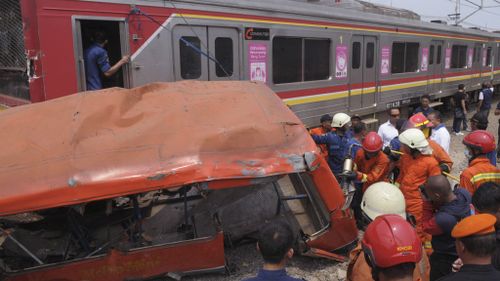 Minibus and commuter train crash in Jakarta kills 18