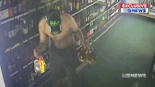 A man fell through the roof of a bottle shop and helped himself to booze.