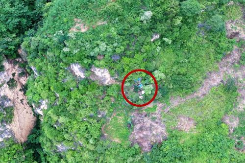 A small blue tile and rubbish outside a secret cave entrance were spotted by a drone, alerting police to Song Jiang's hiding place.