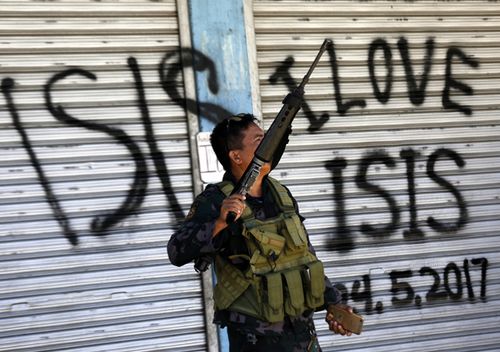 A Filipino government soldier conducts a patrol on a reclaimed former Maute stronghold in Marawi City, Mindanao, in a photo dated May 2017.