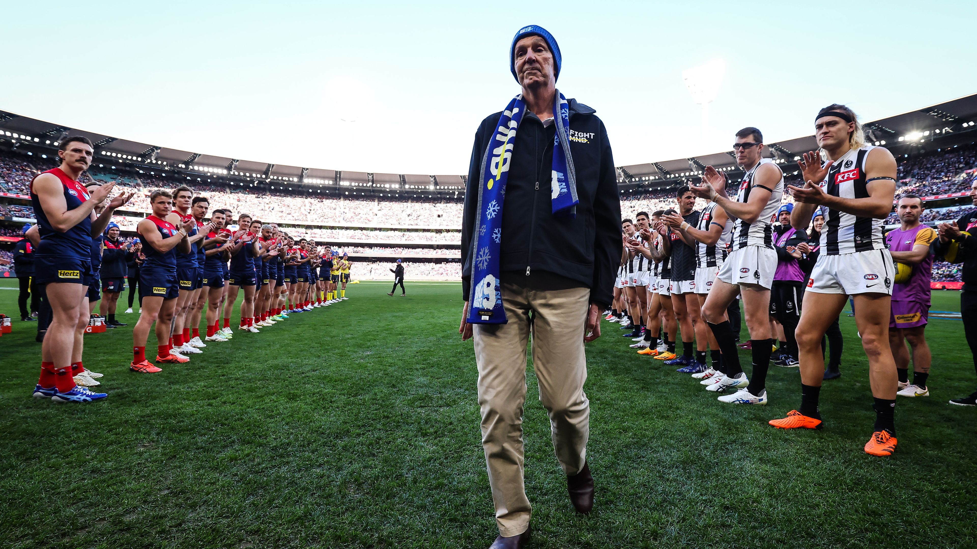 MELBOURNE, AUSTRALIA - JUNE 12: A guard of honour is formed for Neale Daniher during the 2023 AFL Round 13 match between the Melbourne Demons and the Collingwood Magpies at the Melbourne Cricket Ground on June 12, 2023 in Melbourne, Australia. (Photo by Dylan Burns/AFL Photos via Getty Images)
