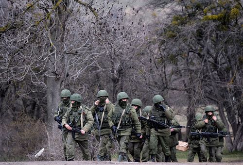 Russian soldiers patrol the area surrounding the Ukrainian military unit in Perevalnoye, outside Simferopol, on March 20, 2014