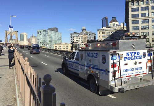 An NYPD emergency service vehicle brings up the rear of a heavily armed federal law enforcement caravan carrying Joaquin Guzman back to a lower Manhattan jail following a pretrial hearing.