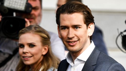 Sebastian Kurz and his partner Susanne Thier (L) arrive at a polling station to cast their votes. (EPA)