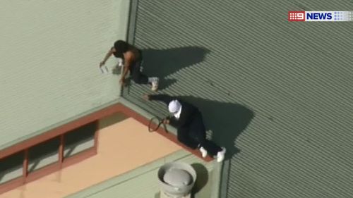 Six inmates holding tennis racquets climb onto roof at Melbourne youth centre