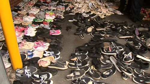 About 1000 pairs of shoes were found in the man's possession. (9NEWS)