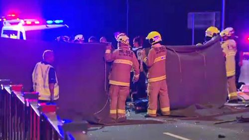 Firefighters work with NSW Ambulance paramedics to assist the injured women.