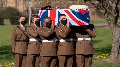 (No reuse after 11.59pm on March 6th 2021 without written consent from gemma@captaintom.org.) The coffin of Captain Sir Tom Moore is carried by members of the Armed Forces during his funeral at Bedford Crematorium on February 27, 2021 in Bedford, England