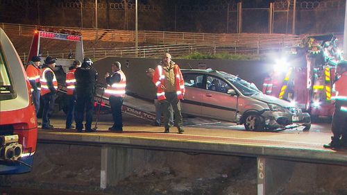 Police allege CCTV footage showed two men pushing the car onto the tracks.