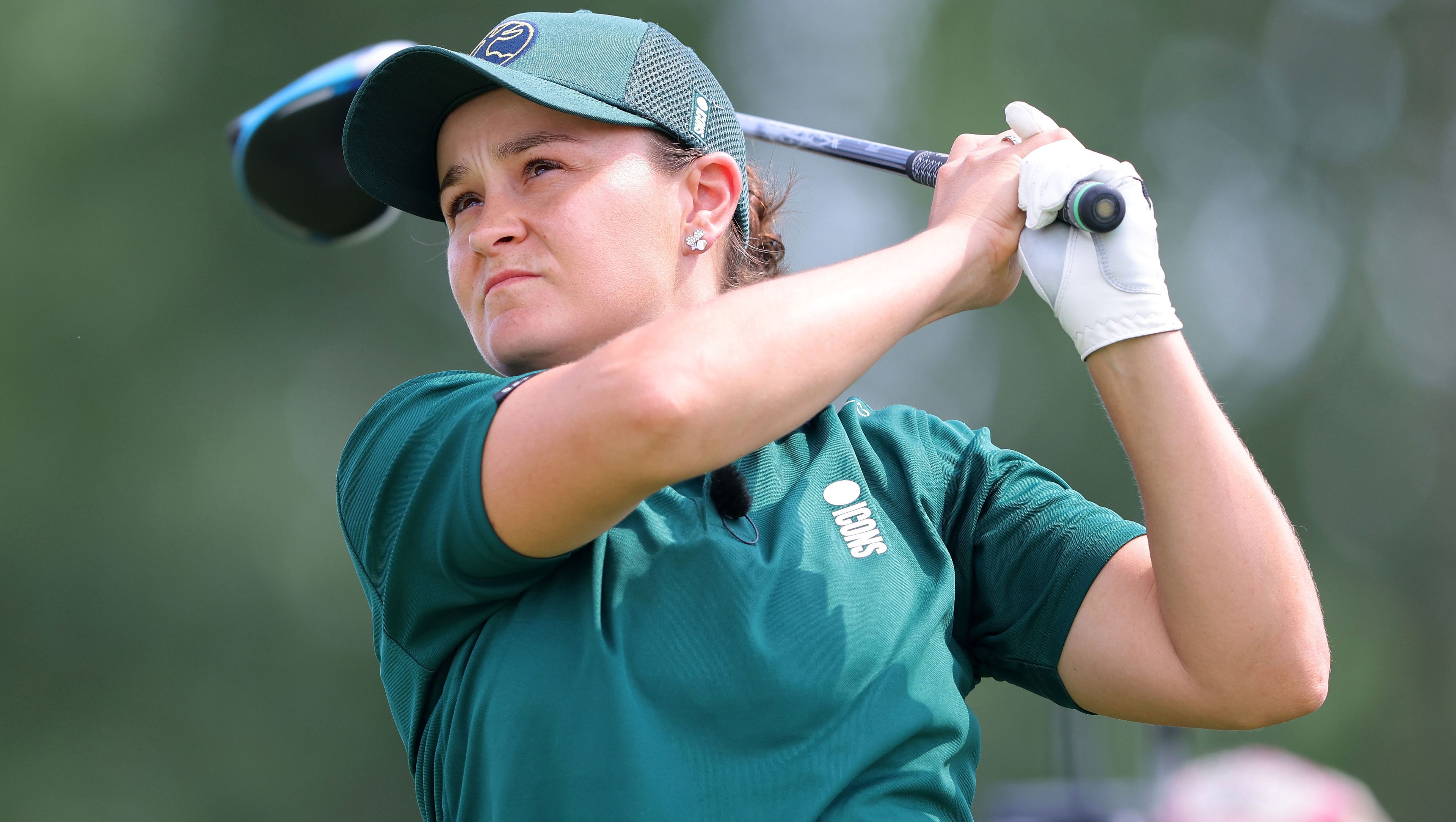 Ash Barty clubs a drive as she plays in a golf tournament.