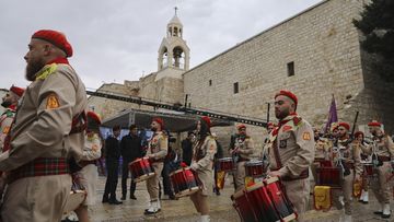 Palestinian scout bands parade through Manger Square at the Church of the Nativity,  traditionally believed to be the birthplace of Jesus Christ, during Christmas celebrations, in the West Bank city of Bethlehem, Friday, Dec. 24, 2021.