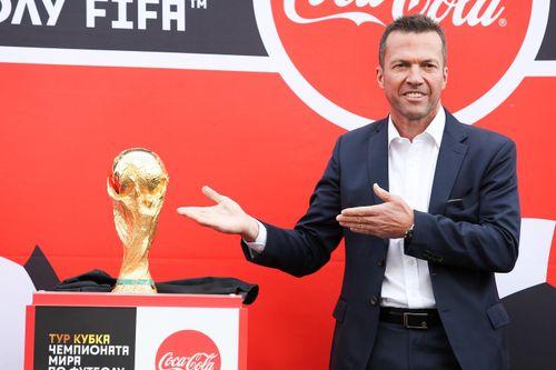 Former German soccer star Lothar Matthaus holds up the trophy during a ceremony to welcome the FIFA World Cup trophy at Manezh Square in Moscow. Picture: AAP