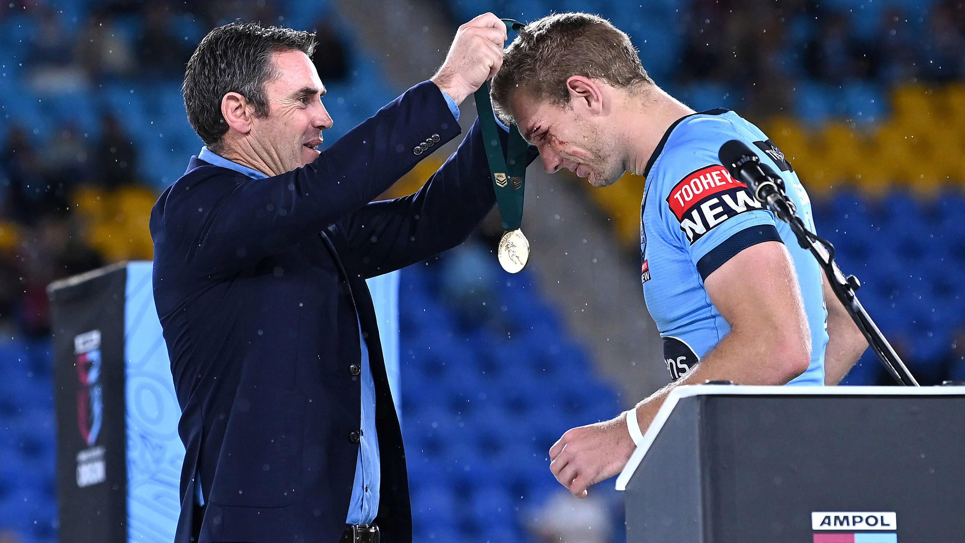 Tom Trbojevic is presented with the Wally Lewis Medal by Brad Fittler for player of the series in the 2021 Origin series.