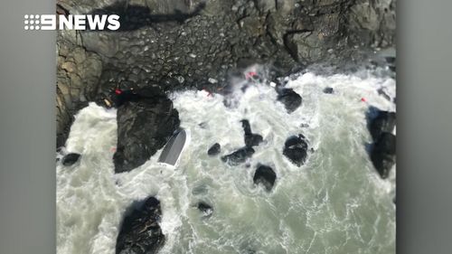 The men were found clinging to rocks.