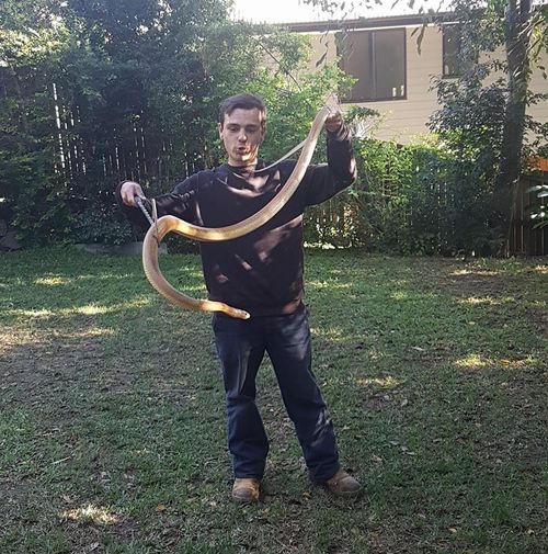 Nathan Chetcuti is fighting for life after being bitten by one of his pet snakes. (Facebook)