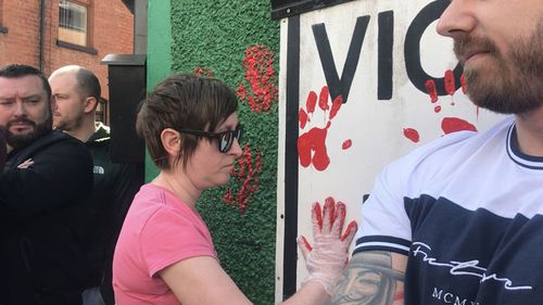 Friends of murdered journalist Lyra McKee defaced the walls of a dissident republican office in Derry with red paint.