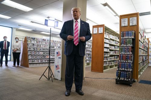 President Donald Trump talks with reporters after casting his ballot in the presidential election, Saturday, Oct. 24, 2020, in West Palm Beach, Fla