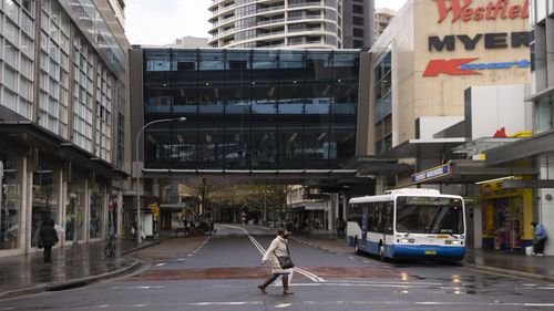 A pedestrian is seen wearing  mask at Bondi Junction on June 21, 2021 in Sydney, Australia. A cluster of COVID-19 cases in Sydney's eastern suburbs continues to grow, causing the government to impose restrictions including mandatory indoor mask-wearing in several jurisdictions. NSW Premier Gladys Berejiklian is urging people to get tested to stop the spread and limit further restrictions.