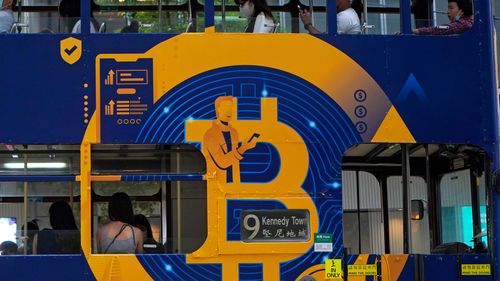 An advertisement of Bitcoin, one of the cryptocurrencies, is displayed on a tram in Hong Kong.