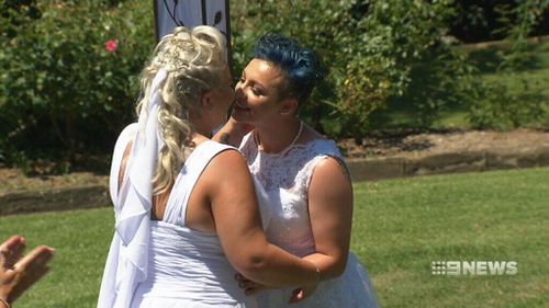 Amy Laker (left) and Lauren Price (right) kiss after legally committing to each other