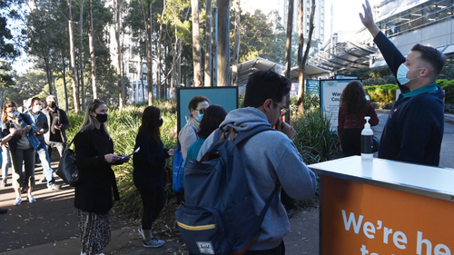 People line up at Sydney Olympic Park's mass vaccination hub.