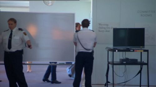 Security guards shielded Senator Cash from the media at Parliament House today. 