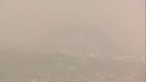 The Sydney Harbour Bridge is barely visible as thick clouds of dust roll eastward.