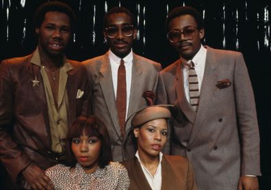 American band Chic on the set of a French TV show. In the background, from left to right: music producer, songwriter, composer, and arranger, Nile Rodgers, drummer Tony Thompson, bassist and also music producer, songwriter, and composer, Bernard Edwards. In the foreground, singers Luci Martin (L) and Alfa Anderson. France, 30th January 1979. (Photo by James Andanson/Sygma via Getty Images)