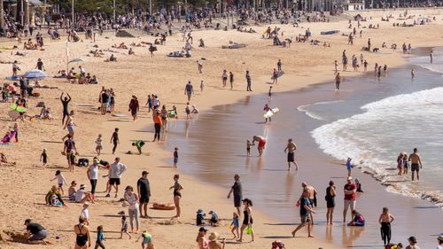Sydneysiders enjoy the warming weather at Manly Beach.