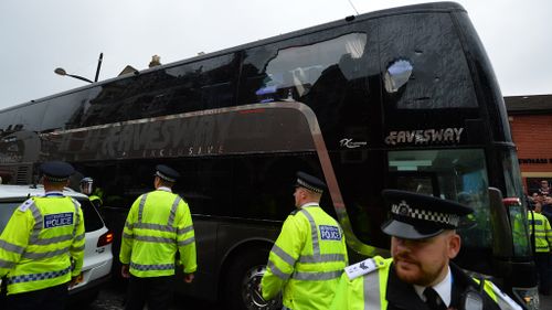 The bus carrying the Manchester United team was escorted by police after having a window smashed on its way to West Ham's Boleyn ground before the English Premier League football match between West Ham United and Manchester United in east London on May 10, 2016. (AFP)