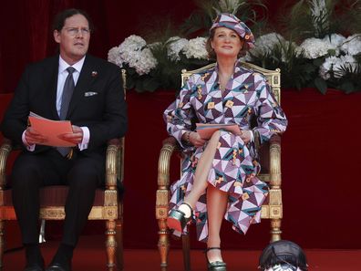 Belgium's Princess Delphine and her husband James O'Hare watch the National Day Parade from the podium in front of the Royal Palace in Brussels, Wednesday, July 21, 2021. Belgium celebrates its National Day on Wednesday in a scaled down version due to coronavirus, COVID-19 measures. (AP Photo/Olivier Matthys)